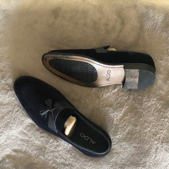 A pair of suede dark blue loafers .